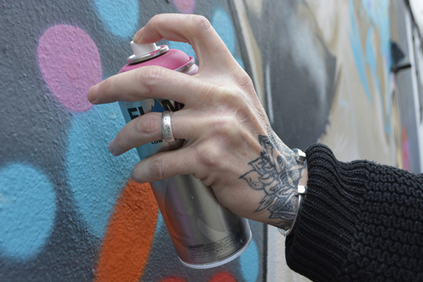 Cally Trench, Left hand of Cize One with 'Urban Authenticity' on the wall of Swanley Mills Tattoos, 27th April 2019